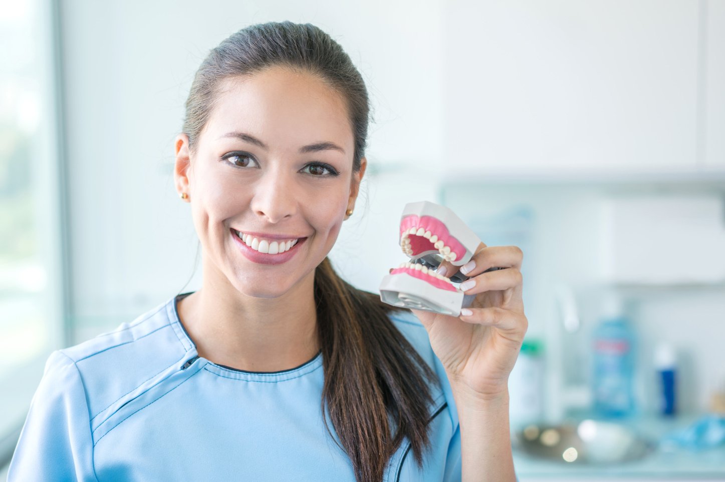 Dentist holding a denture